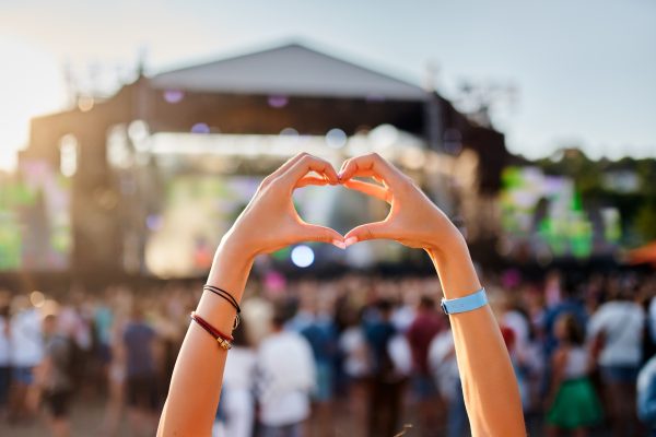 two hands forming a heart at a music festival
